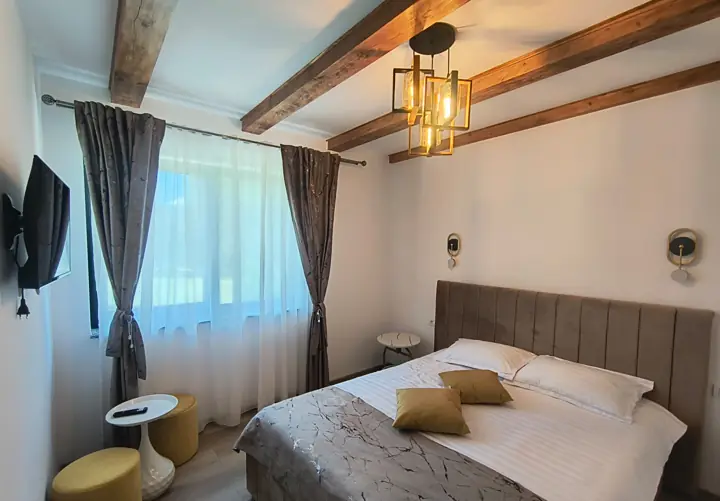 Cameră matrimonială cu grinzi de lemn